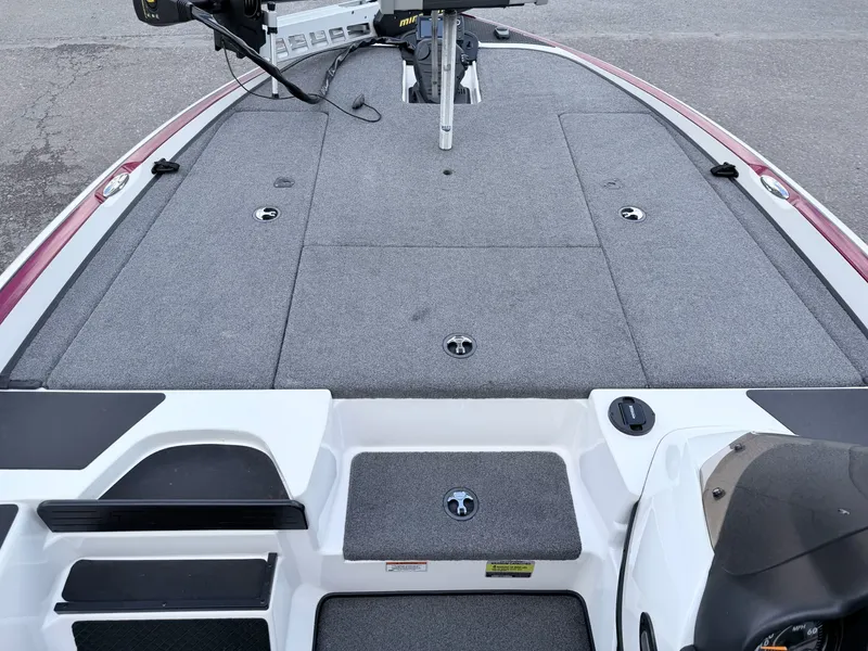 Slide: The Image of 2008 Triton 18X2 boat with gray deck and storage compartments. - 32