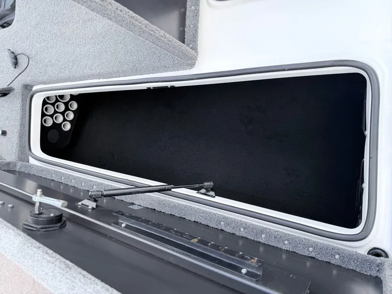 Slide: The Image of Triton 18X2 2008 boat storage compartment with rod holders. - 35