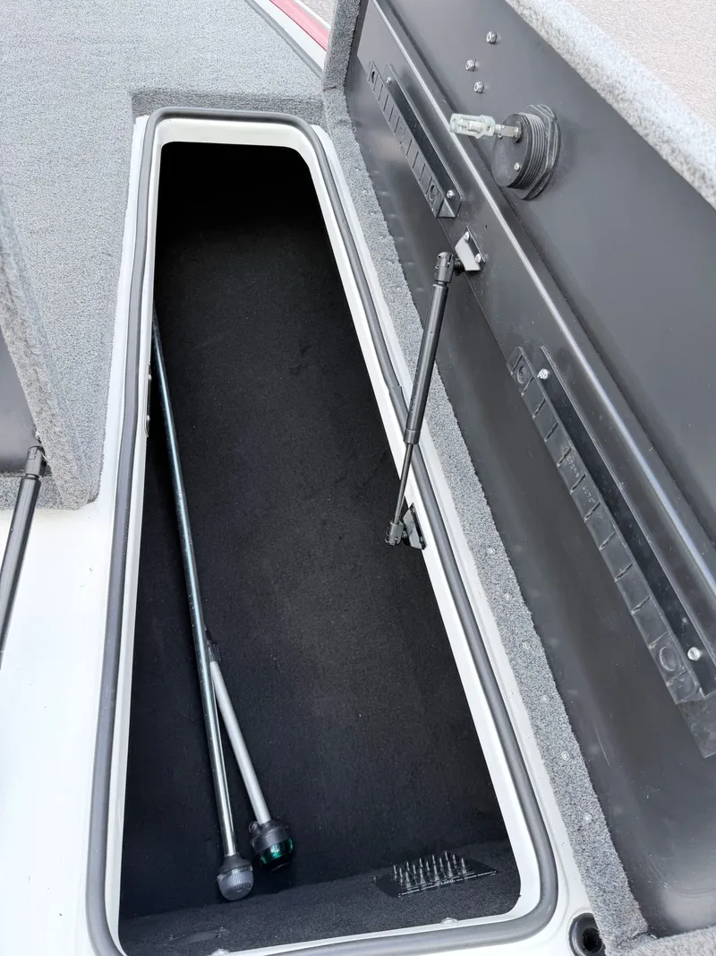 Slide: The Image of 2008 Triton 18X2 boat storage compartment with rod holder. - 8