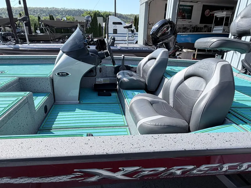 Slide: The Image of 2017 Xpress X19 boat with gray seats and turquoise flooring. - 10