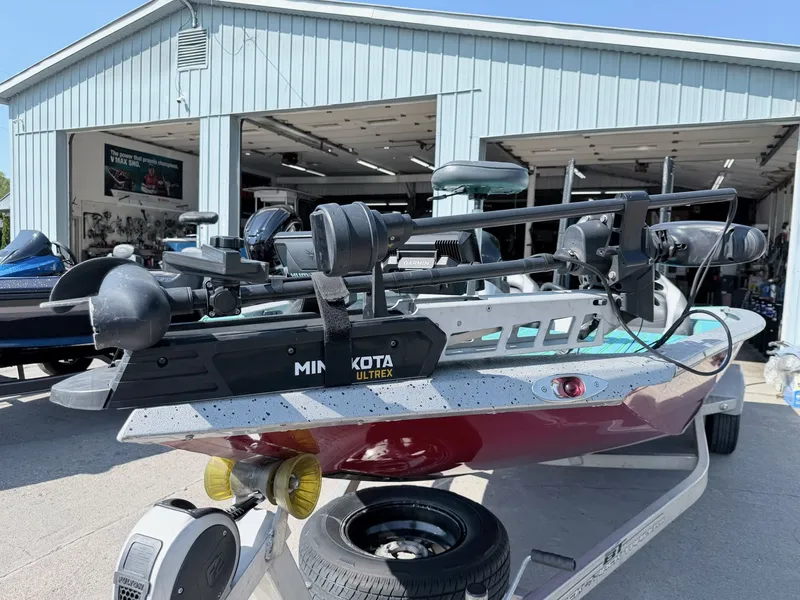 Slide: The Image of 2017 Xpress X19 boat with Minn Kota Ultrex motor in front of garage. - 19