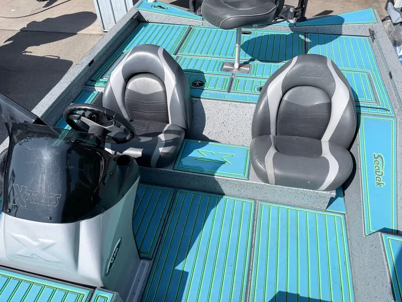 Slide: The Image of 2017 Xpress X19 boat with gray seats and blue flooring. - 22