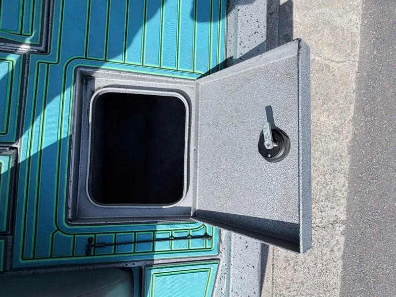 Slide: The Image of Open storage compartment on a 2017 Xpress X19 boat. - 23