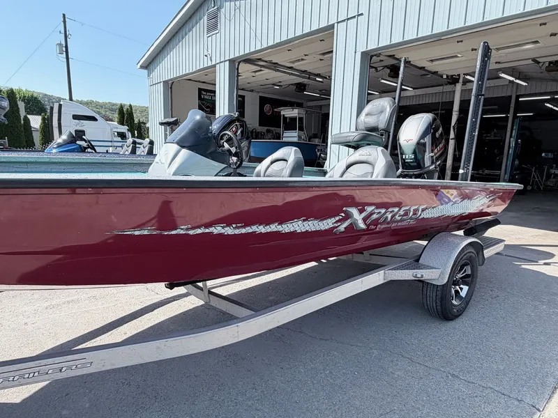 Slide: The Image of 2017 Xpress X19 boat on trailer outside workshop. - 26