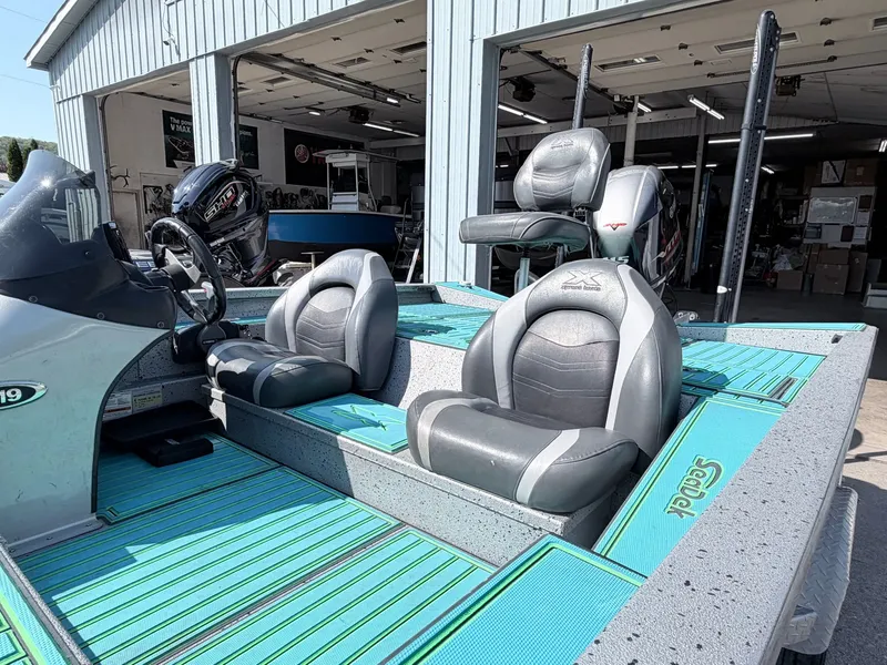 Slide: The Image of 2017 Xpress X19 boat with gray seats and turquoise flooring. - 29