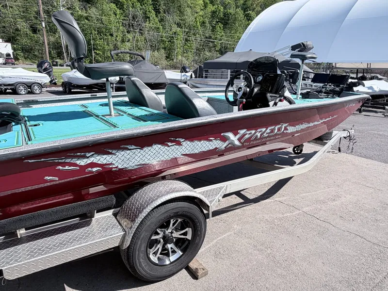Slide: The Image of 2017 Xpress X19 boat on trailer, red with blue seats. - 30