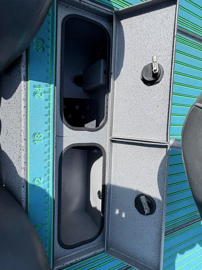 Slide: The Image of 2017 Xpress X19 boat with open storage compartment and measuring tape. - 34
