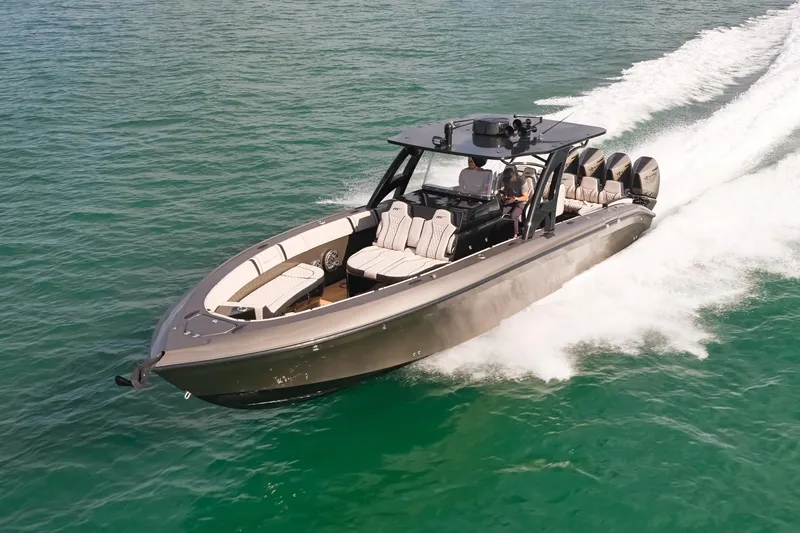 Slide: The Image of 2025 Midnight Express 37 Open boat cruising on clear blue water. - 1
