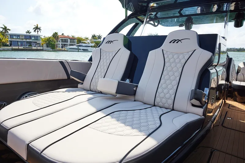 Slide: The Image of Luxurious seating on the 2025 Midnight Express 37 Open boat, with waterfront view. - 10
