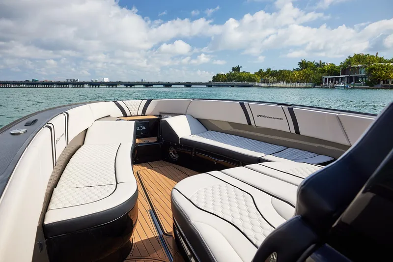 Slide: The Image of Luxurious 2025 Midnight Express 37 Open boat interior with elegant seating and scenic waterfront view. - 11