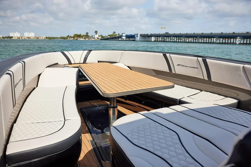 Slide: The Image of Luxurious seating area on 2025 Midnight Express 37 Open boat with scenic water view. - 12
