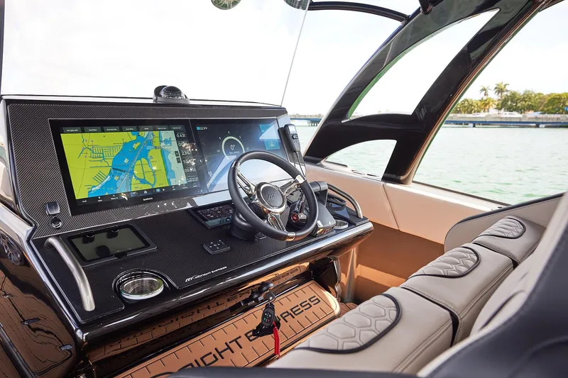 Slide: The Image of Helm of 2025 Midnight Express 37 Open boat with advanced navigation system. - 13