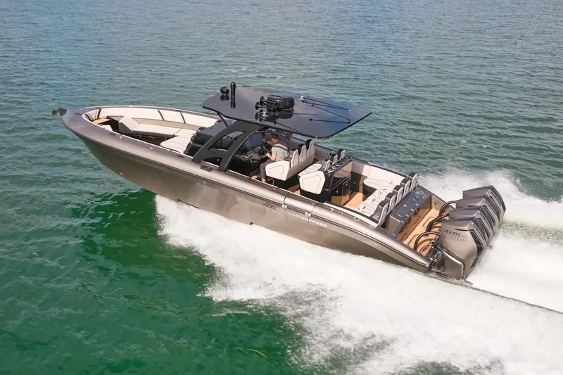 Slide: The Image of 2025 Midnight Express 37 Open boat cruising on clear water with powerful engines. - 2