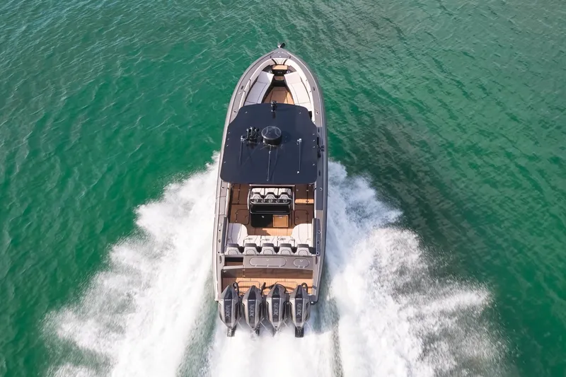Slide: The Image of 2025 Midnight Express 37 Open cruising on clear turquoise water. - 3