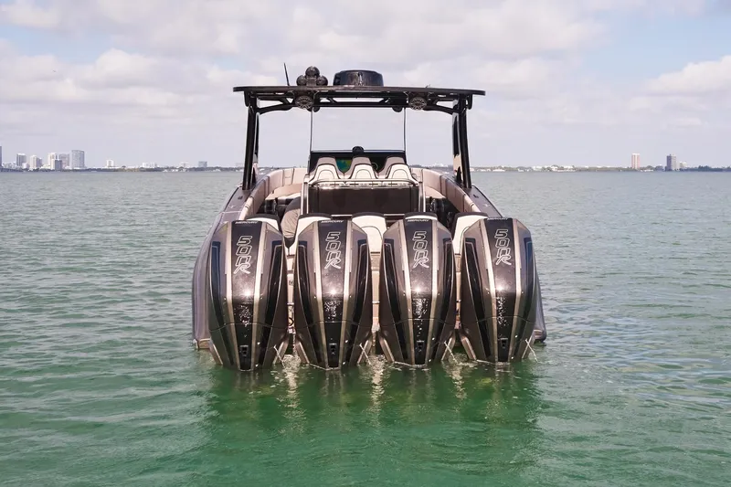 Slide: The Image of 2025 Midnight Express 37 Open boat with powerful Mercury 500R engines on calm water. - 6