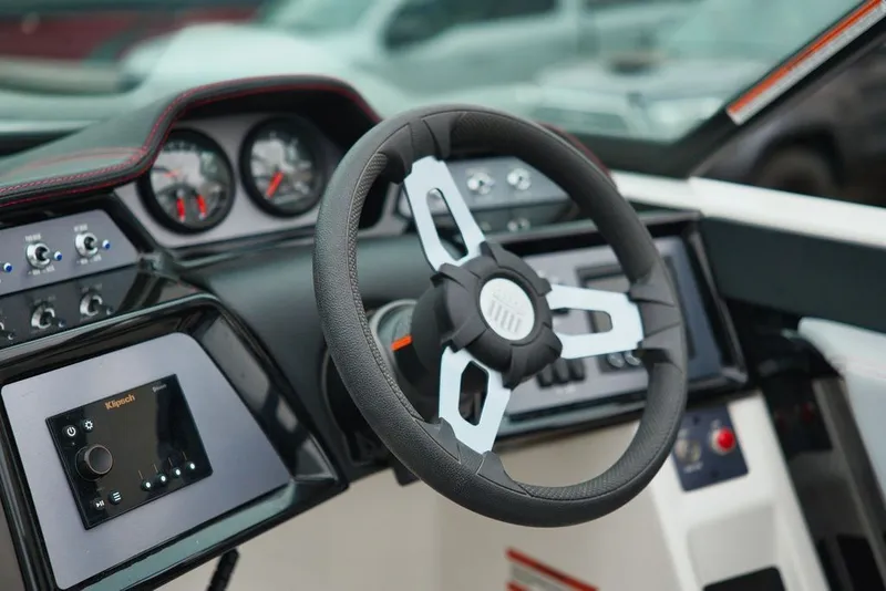 Slide: The Image of 2022 MasterCraft NXT22 steering console with modern controls. - 11