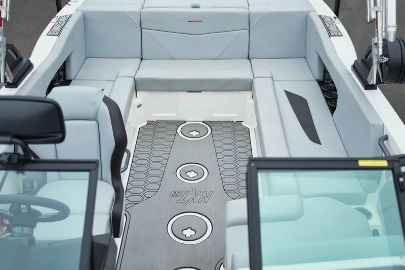 Slide: The Image of Interior of 2022 MasterCraft NXT22 boat with gray upholstery. - 13