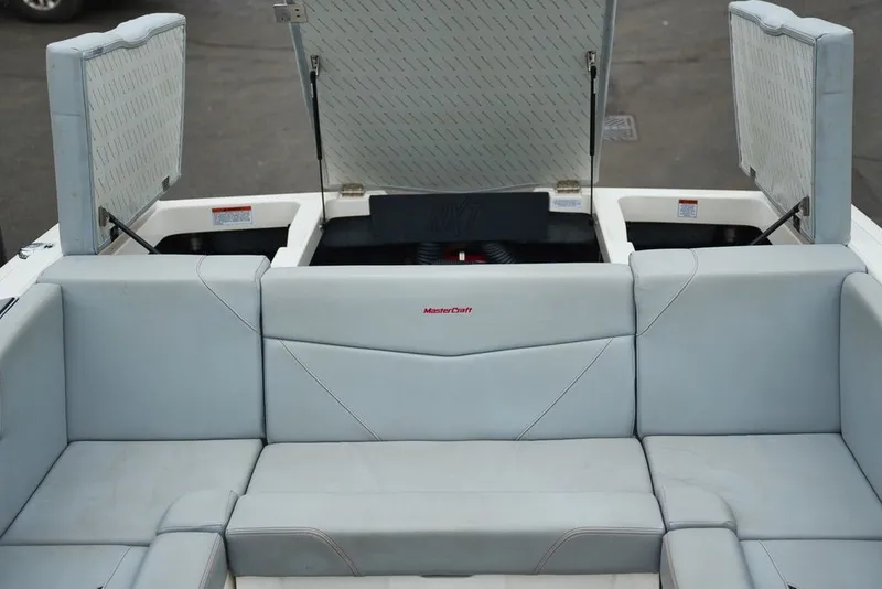 Slide: The Image of 2022 MasterCraft NXT22 boat with open storage and seating area. - 15