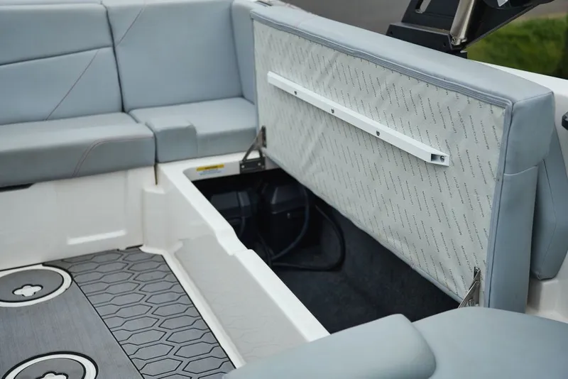 Slide: The Image of Interior of a 2022 MasterCraft NXT22 boat with grey upholstery. - 16
