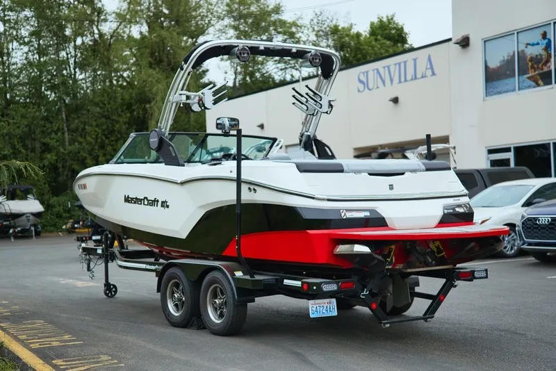 Slide: The Image of 2022 MasterCraft NXT22 boat on trailer in front of Sunvilla. - 4