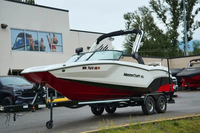Slide: The Image of 2022 MasterCraft NXT22 boat on trailer in front of building. - 6