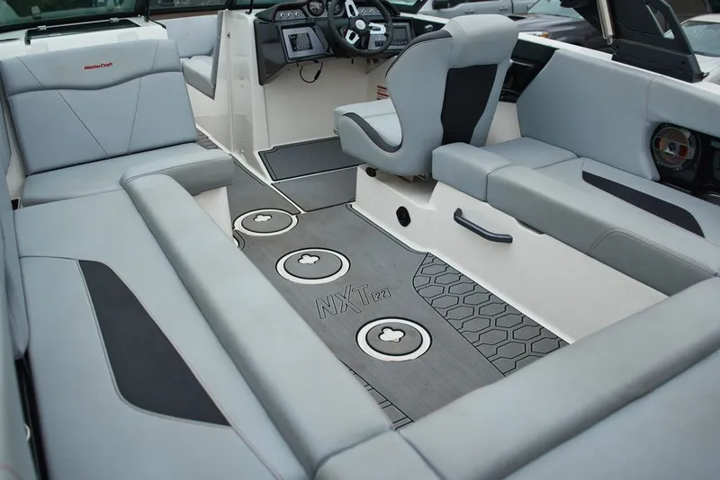 Slide: The Image of Interior of 2022 MasterCraft NXT22 boat with gray upholstery. - 9