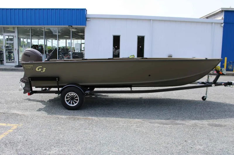 The Image of 2026 G3 Outfitter V187 T boat on trailer in front of building. - 1