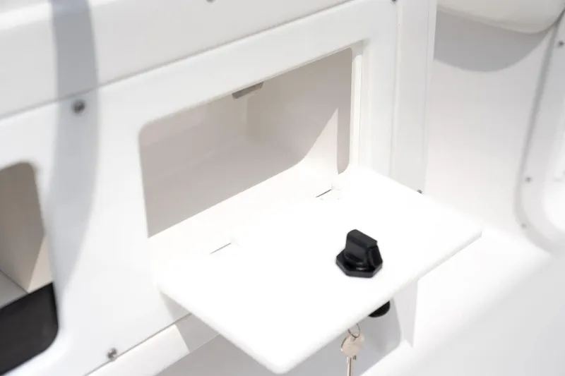Slide: The Image of Stingray 173 CC 2026 boat, open storage compartment with black latch. - 3