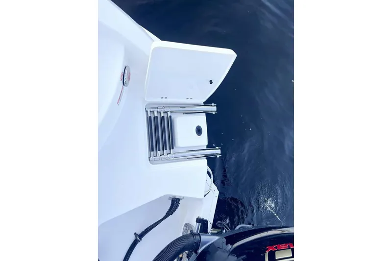 Slide: The Image of Stingray 23 OSX 2026 boat with swim ladder at stern. - 11