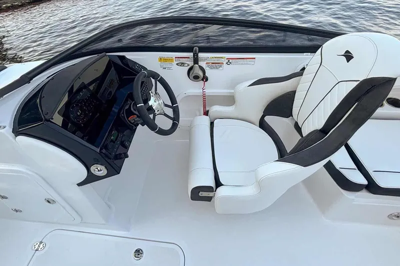 Slide: The Image of Interior of 2026 Stingray 23 OSX boat with steering console. - 6