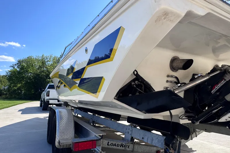 Slide: The Image of 2000 Fountain 27 Fever boat on trailer, featuring sleek design and vibrant graphics. - 11