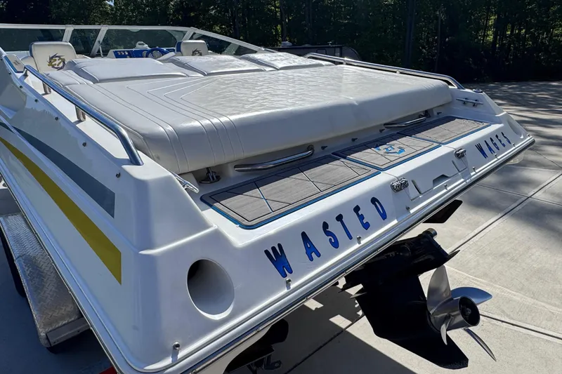 Slide: The Image of 2000 Fountain 27 Fever boat with "Wasted" name, docked on a sunny day. - 12