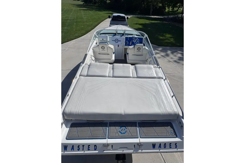 Slide: The Image of 2000 Fountain 27 Fever boat with white seating and "Wasted Wages" text on the back. - 16