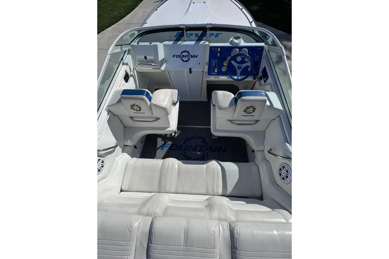 Slide: The Image of 2000 Fountain 27 Fever boat interior with white seating and blue dashboard. - 18