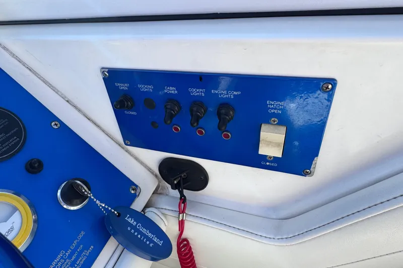 Slide: The Image of Control panel of a 2000 Fountain 27 Fever boat with various switches and labels. - 20