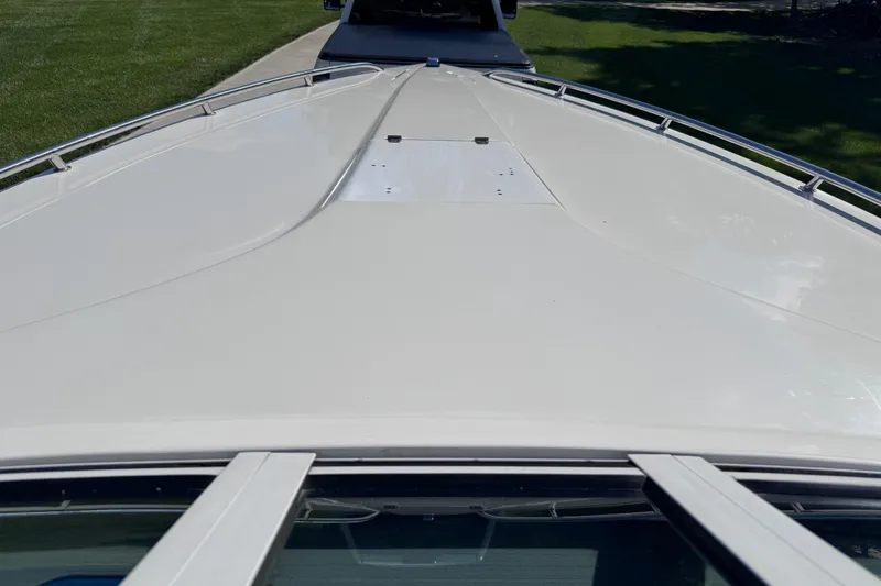 Slide: The Image of 2000 Fountain 27 Fever boat deck, sleek design, parked on grass. - 24