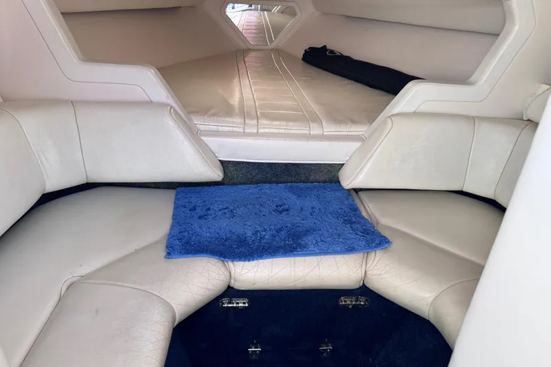 Slide: The Image of Interior of a 2000 Fountain 27 Fever boat with white seating and blue carpet. - 25