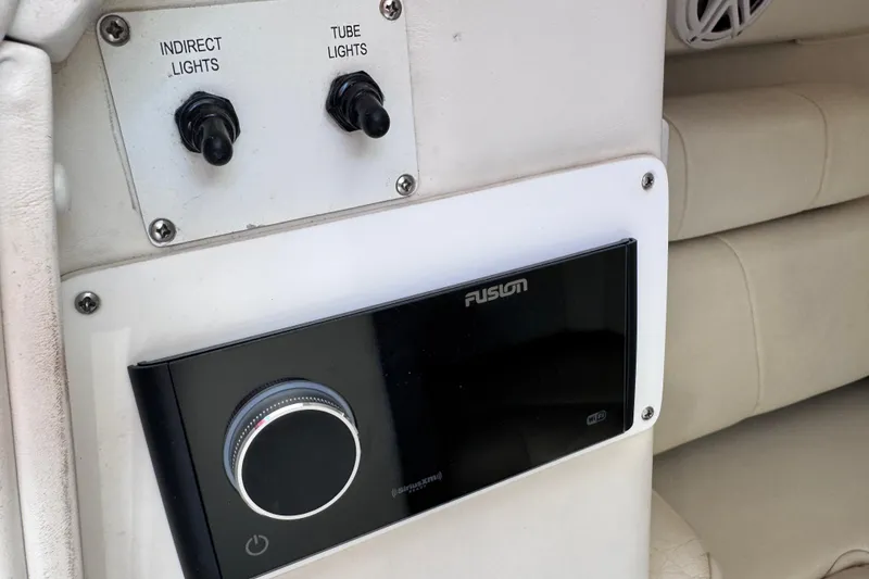Slide: The Image of Control panel with light switches and Fusion stereo on 2000 Fountain 27 Fever boat. - 26