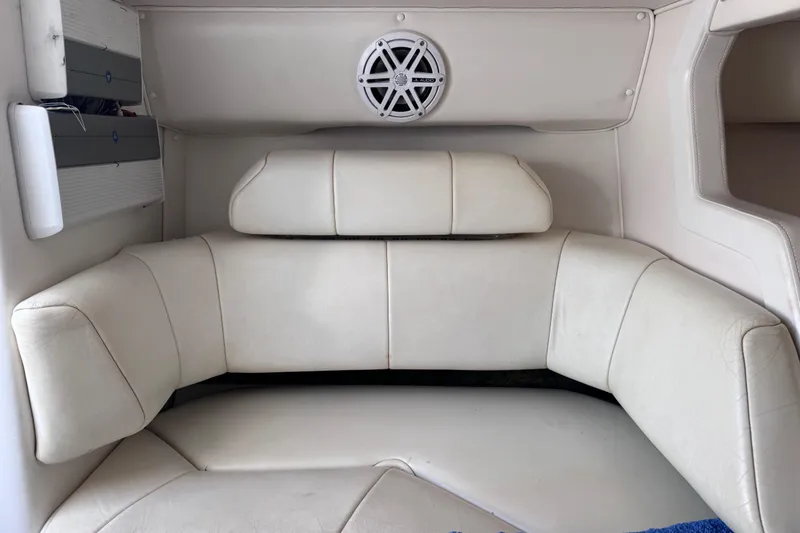 Slide: The Image of Interior of a 2000 Fountain 27 Fever boat with white cushioned seating. - 27