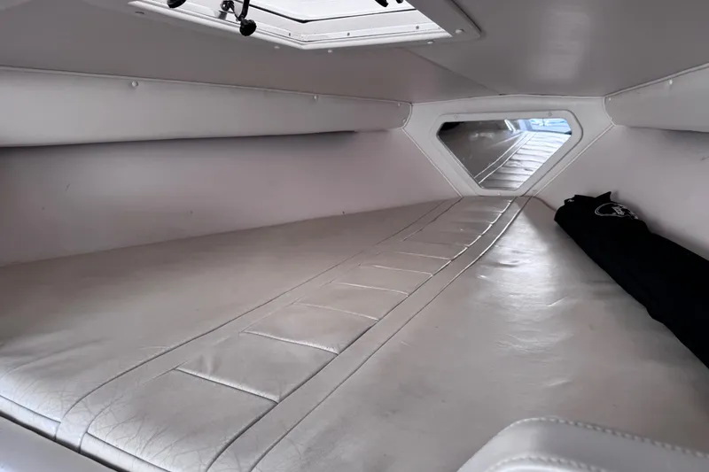 Slide: The Image of Interior cabin of a 2000 Fountain 27 Fever boat with white upholstery. - 28