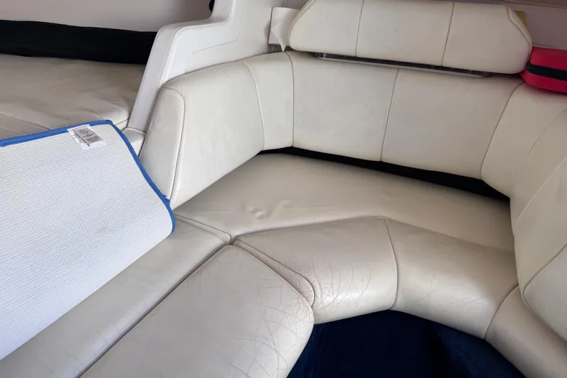 Slide: The Image of Interior seating of a 2000 Fountain 27 Fever boat with white upholstery. - 29