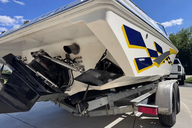 Slide: The Image of 2000 Fountain 27 Fever boat on trailer, showcasing rear design and graphics. - 3