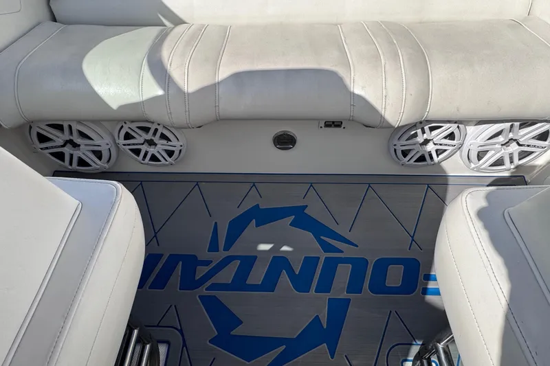 Slide: The Image of Interior of a 2000 Fountain 27 Fever boat with white seating and speaker system. - 32