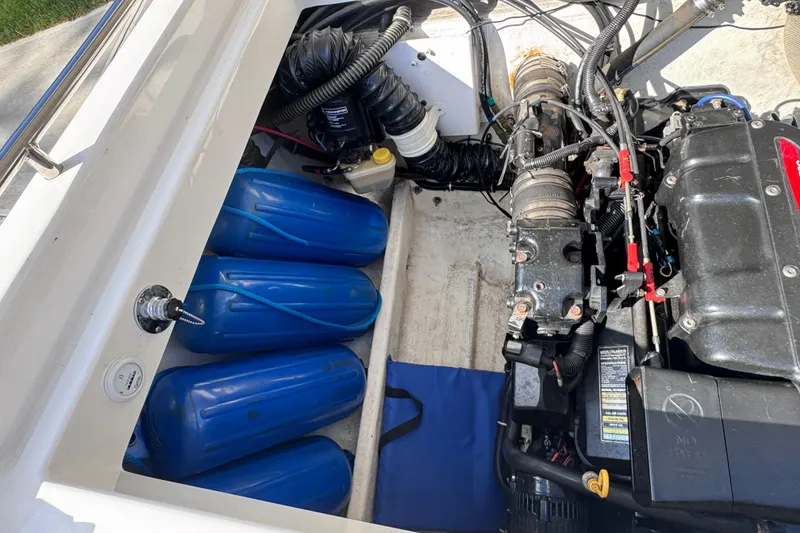 Slide: The Image of Engine compartment of a 2000 Fountain 27 Fever boat with blue fenders and mechanical components. - 34