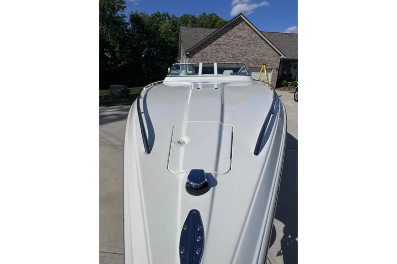 Slide: The Image of 2000 Fountain 27 Fever boat parked in driveway, showcasing sleek white design. - 7