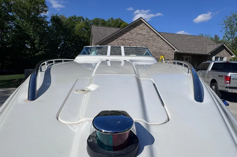 Slide: The Image of 2000 Fountain 27 Fever boat parked in driveway, showcasing sleek design under clear blue sky. - 8
