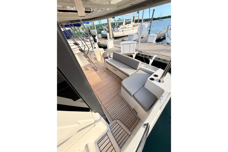 Slide: The Image of 2021 Beneteau Swift Trawler 41 Fly deck with seating, docked at marina. - 12