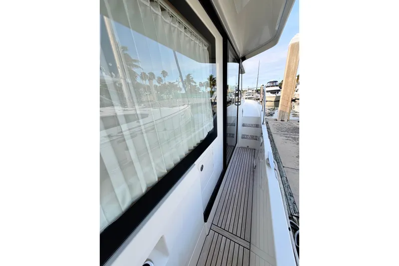 Slide: The Image of Side deck view of 2021 Beneteau Swift Trawler 41 Fly at marina. - 13
