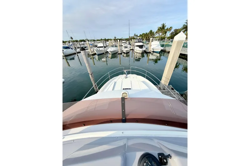 Slide: The Image of 2021 Beneteau Swift Trawler 41 Fly docked at a marina with other boats. - 14