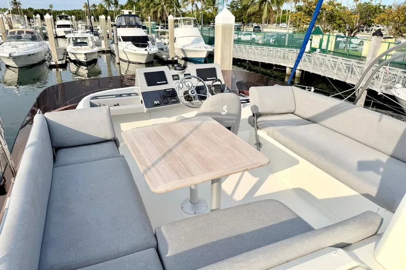 Slide: The Image of Flybridge of 2021 Beneteau Swift Trawler 41 Fly with seating and helm, docked at marina. - 19
